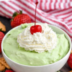 pinterest graphic of a white bowl full of pistachio dip with strawberries and crackers around it, says: delicious pistachio dip simplejoy.com