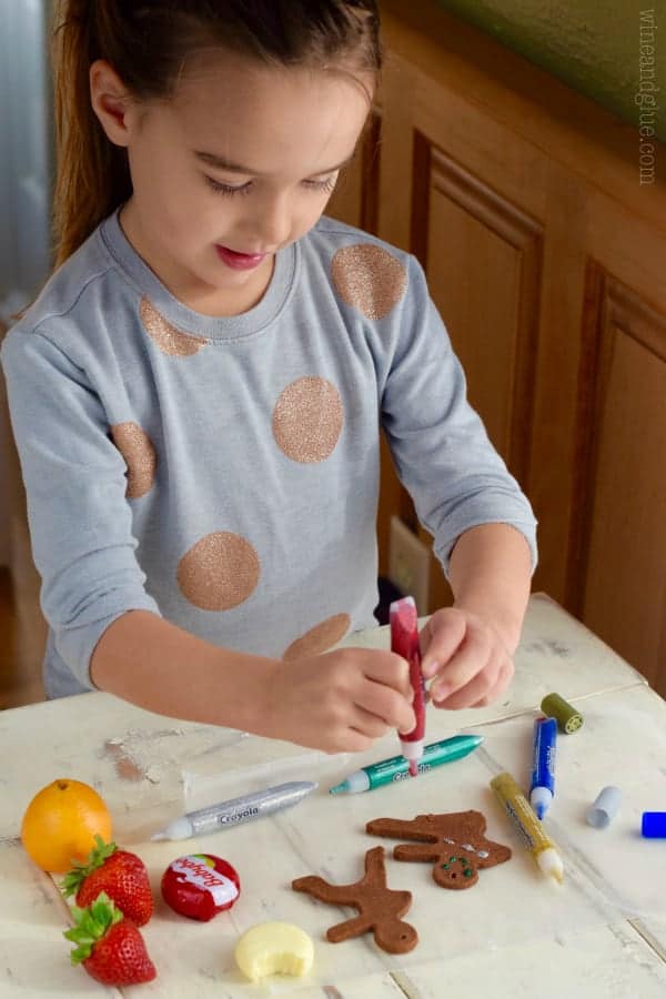 These Gingerbread Man Christmas Ornaments are such a fun easy holiday craft that smell just like gingerbread cookies! Perfect for a fun activity with the kiddos or gifting!