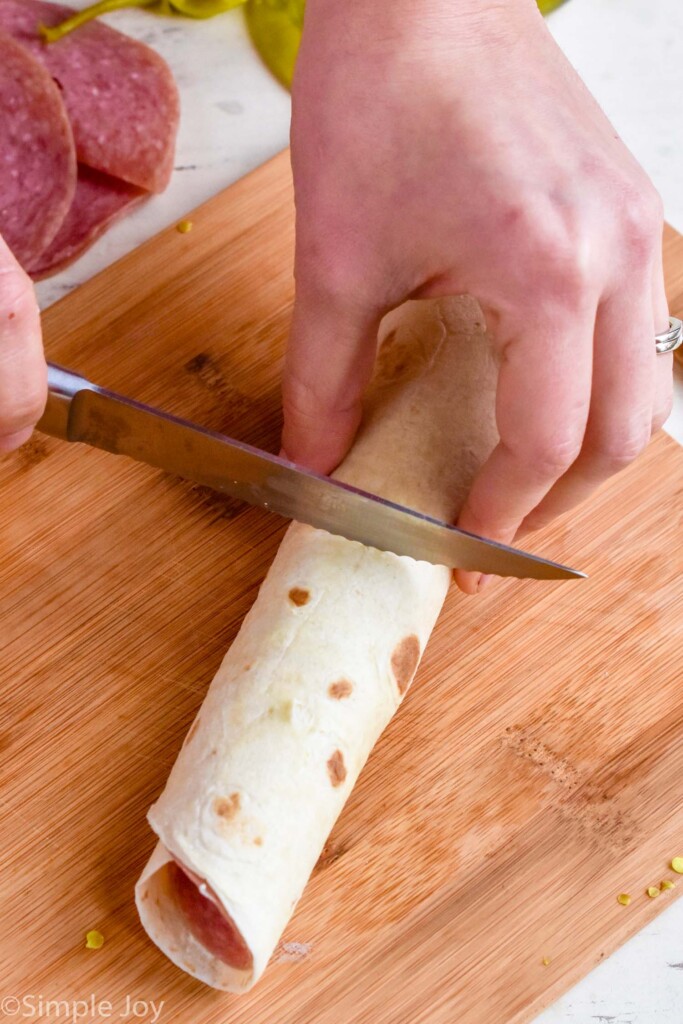 rolled up tortilla being cut up