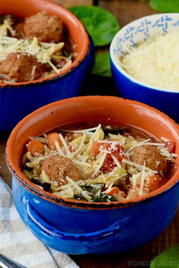 Two blue bowls of vegetable and meatball soup