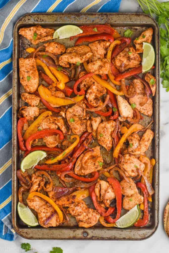 overhead view of baking sheet of chicken fajitas to out of the oven