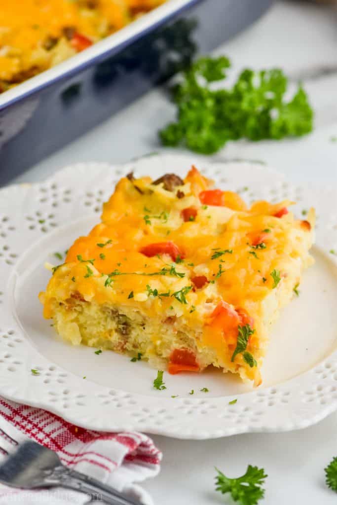 square piece of sausage hash brown casserole on a white plate 