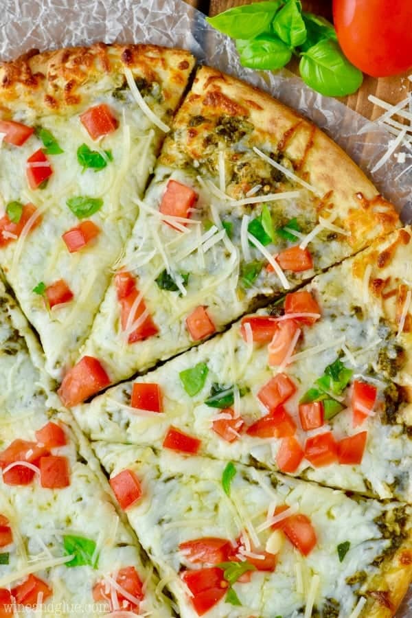 This Easy Pesto Pizza comes together in less than 15 minutes! A perfect busy weeknight meal or a fun party appetizer!