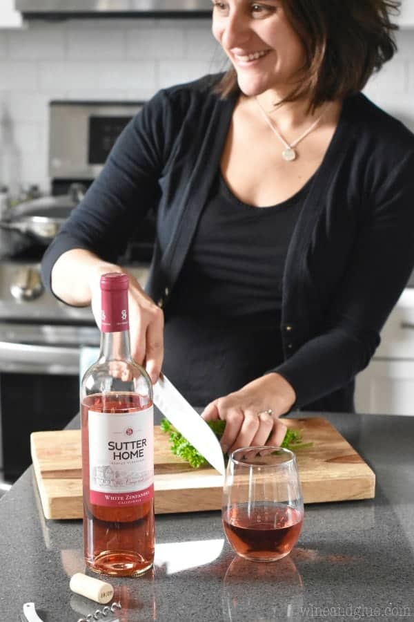 woman in the kitchen with a glass of Sutter Home White Zinfandel wine