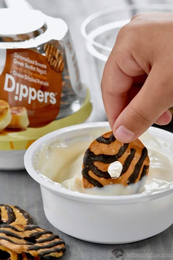 A woman dipping Yoplait's newest snack Dippers into the sauce