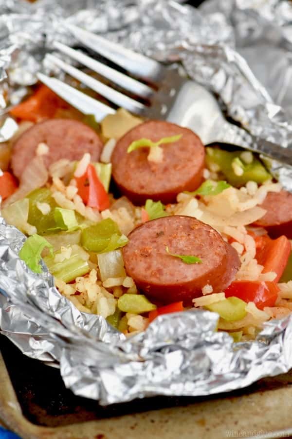 A close up of a Jambalaya Foil Packet which has an array of sausages, peppers, onions, rice, and many more