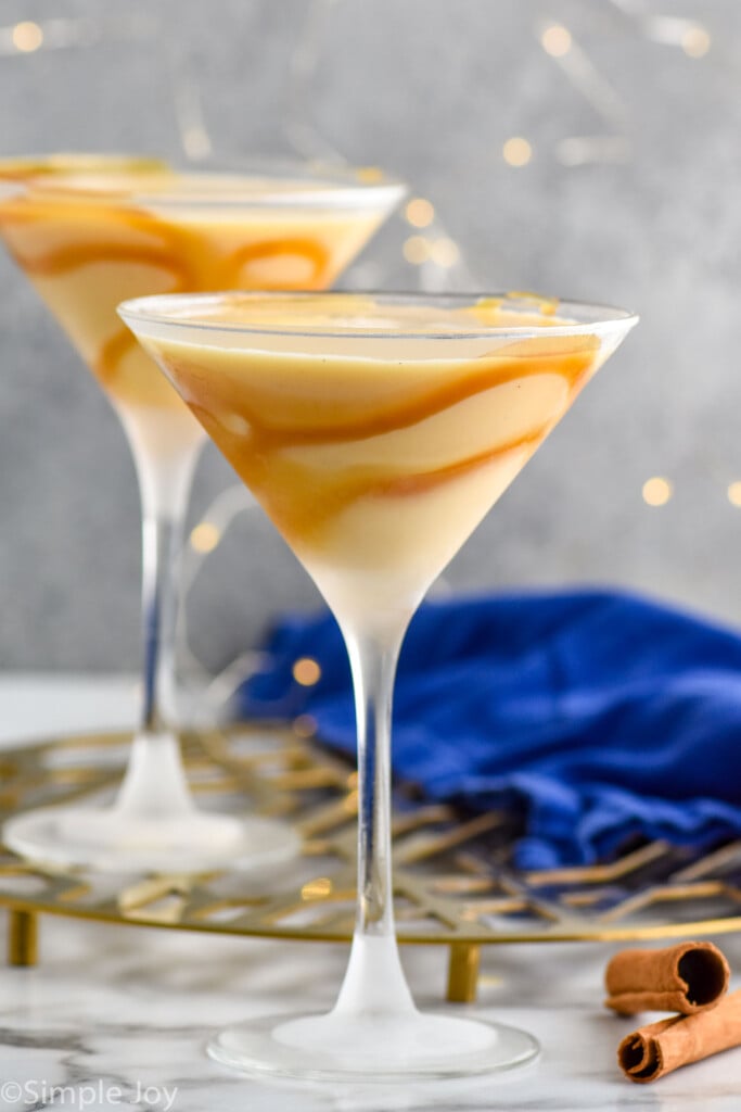 side view of two martini glasses containing eggnog martini cocktail