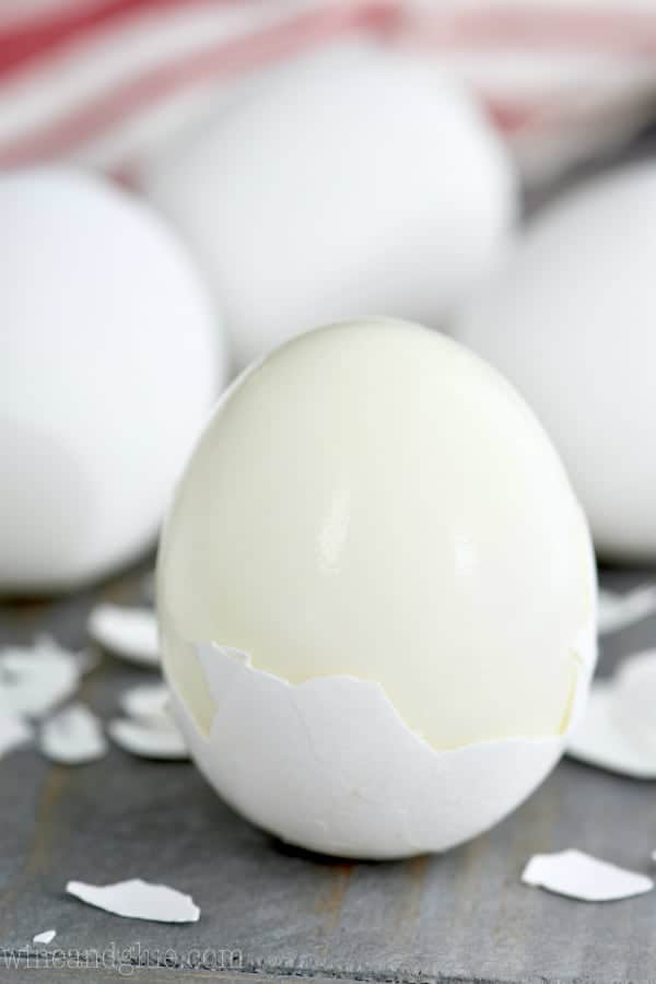 a hard boiled egg that has half of it's shell missing