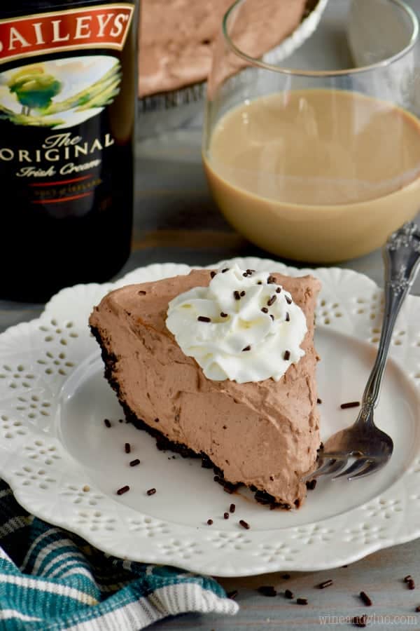 A slice of No Bake Baileys Chocolate Pie with a small dollop of whip cream and chocolate sprinkles. 