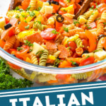 pinterest graphic of italian pasta salad in a large clear bowl garnished with parsley, says: italian pasta salad simplejoy.com