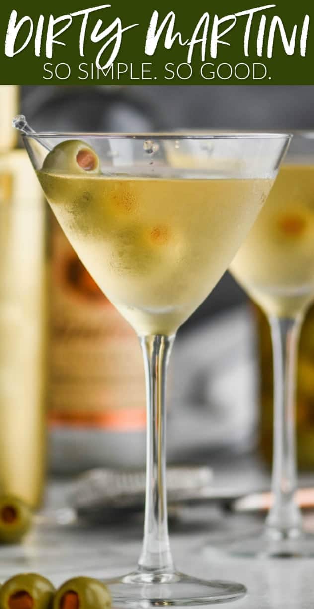 straight on view of a frosted martini glass with a dirty martini in it, garnished with three olives