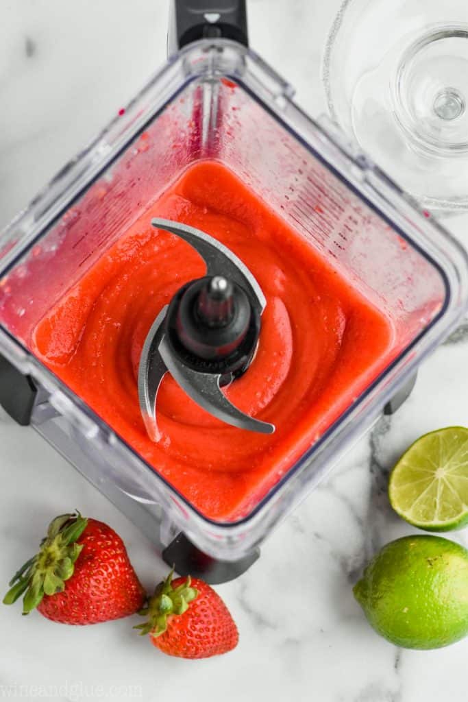 overhead view of blender filled with frozen strawberry margaritas