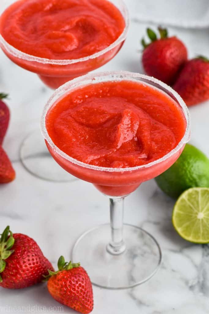 traditional margarita glass rimmed with sugar and full of strawberry margaritas