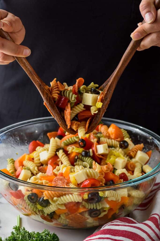 cold Italian pasta salad being tossed