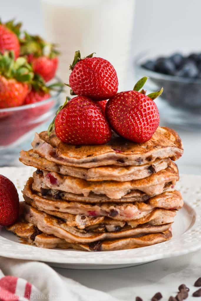 stack of strawberry chocolate chip pancakes with strawberries on top