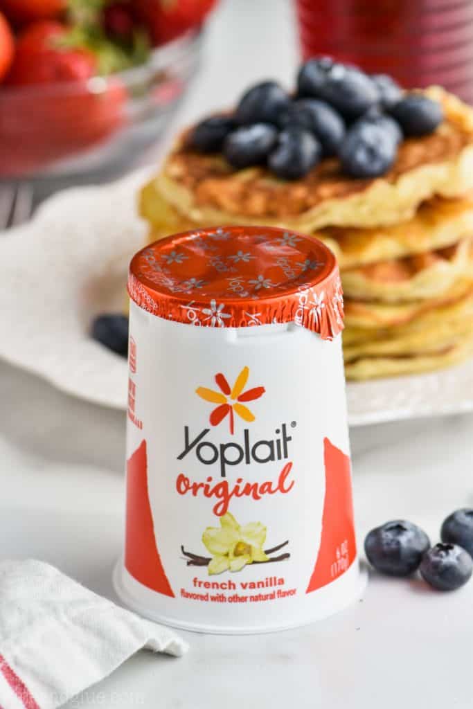 container of 6 ounce Yoplait Original with pancakes in the background