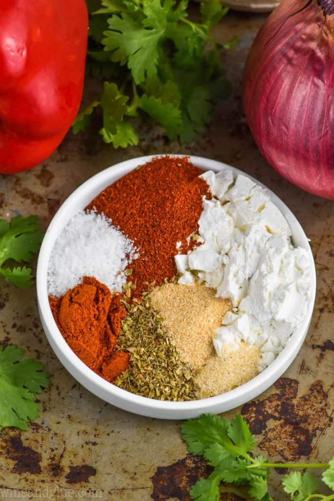 overhead view of fajita seasoning recipe in a small dish with ingredients separated