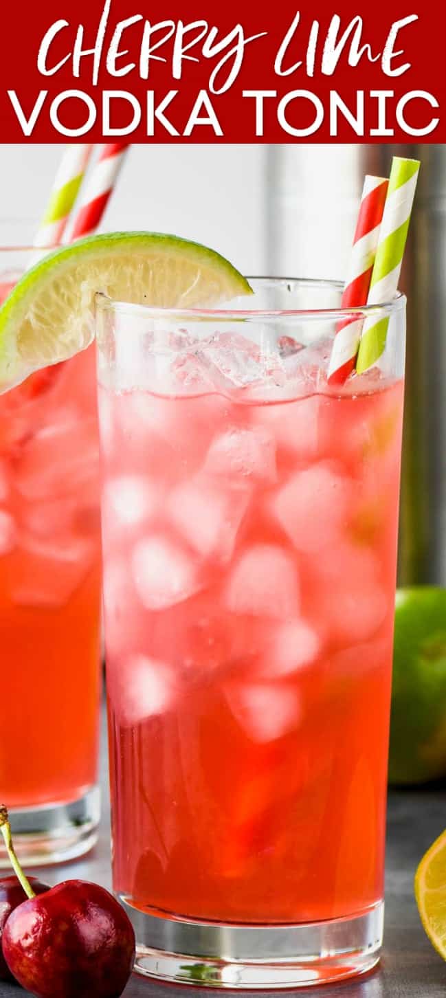 up close view of a high ball glass filled with ice and cherry lime vodka tonic and garnished with a lime wedge