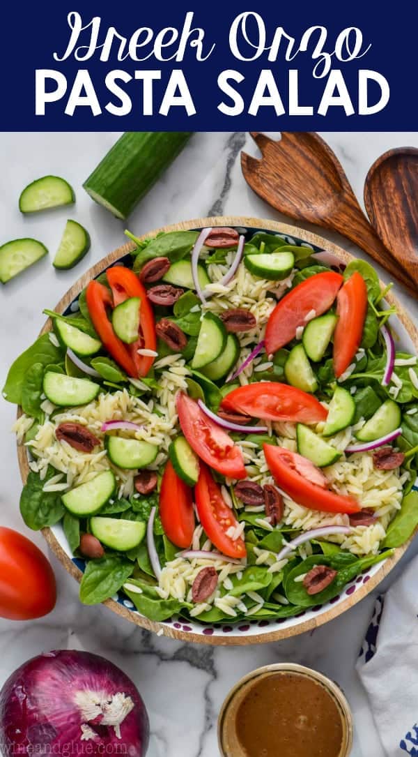 overhead view of greek orzo pasta salad with tomatoes, cucumbers, red onion, orzo and spinach