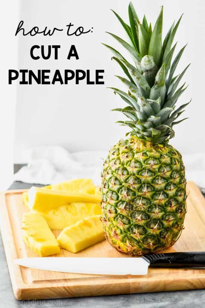 a whole pineapple on a cutting board waiting t be cut