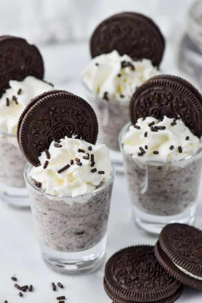 four shot glasses full of cookies and cream pudding shots
