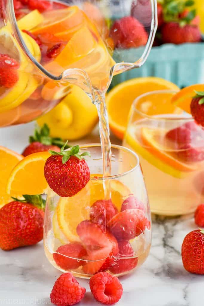 easy white sangria recipe for a crowd being poured into a glass