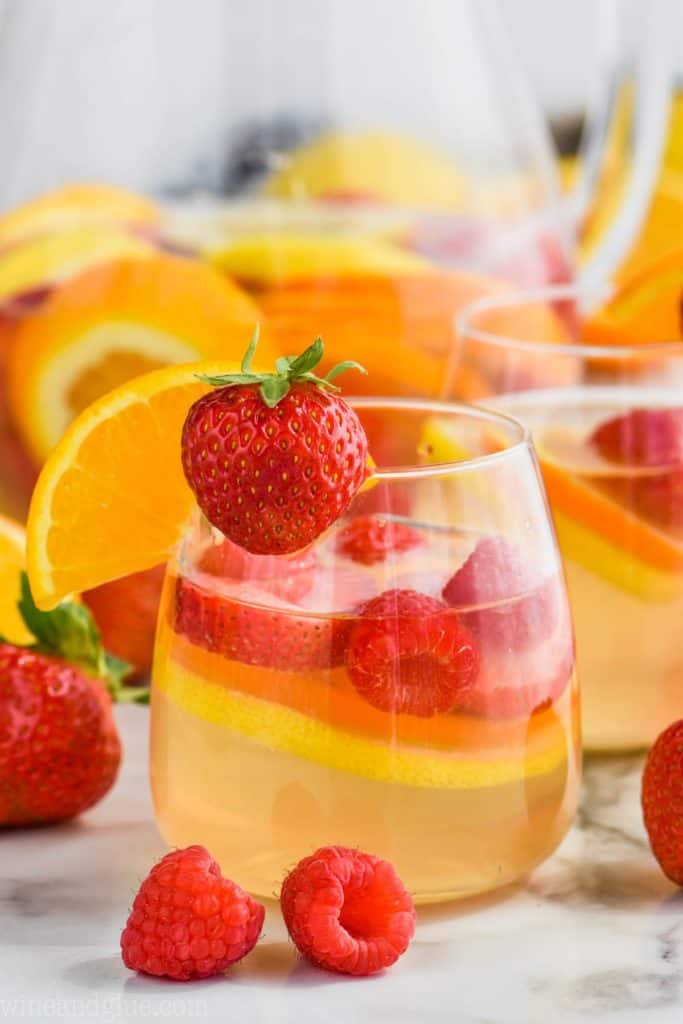 glass of easy white sangria recipe with strawberry and orange