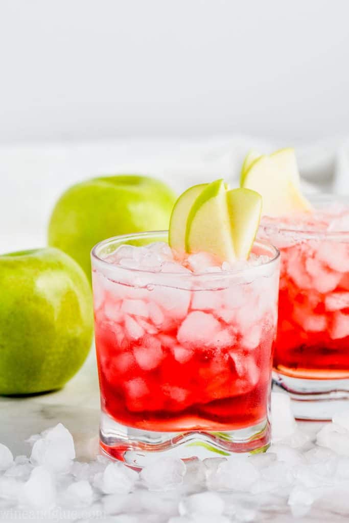 cranberry apple whiskey cocktail garnished with apple