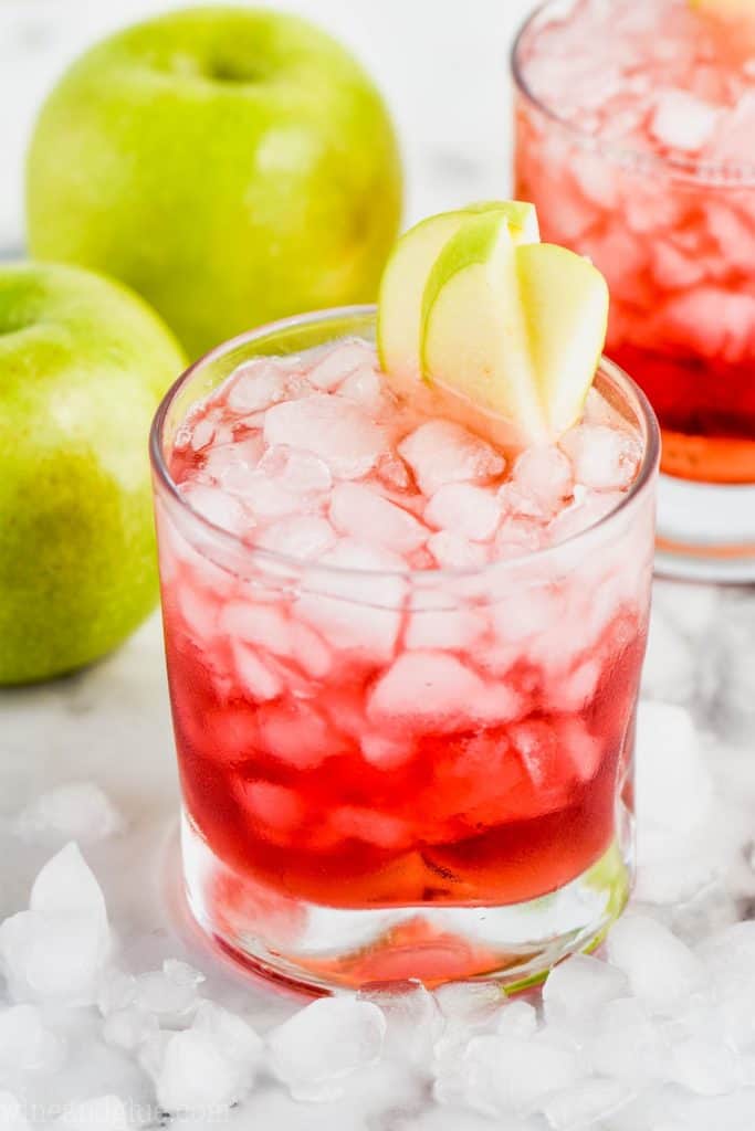 cranberry apple whiskey cocktail garnished with apple