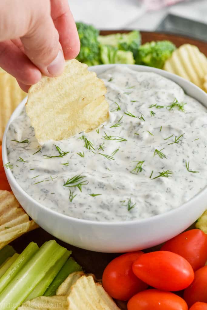 up close of chip being dipped into dill dip recipe