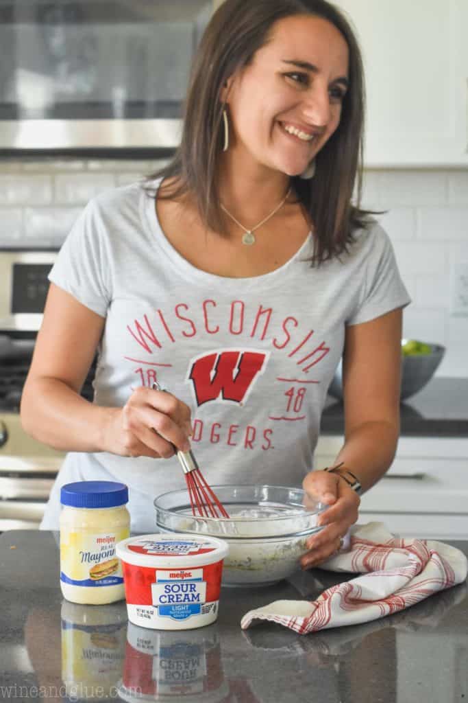 woman stirring dill vegetable dip recipe