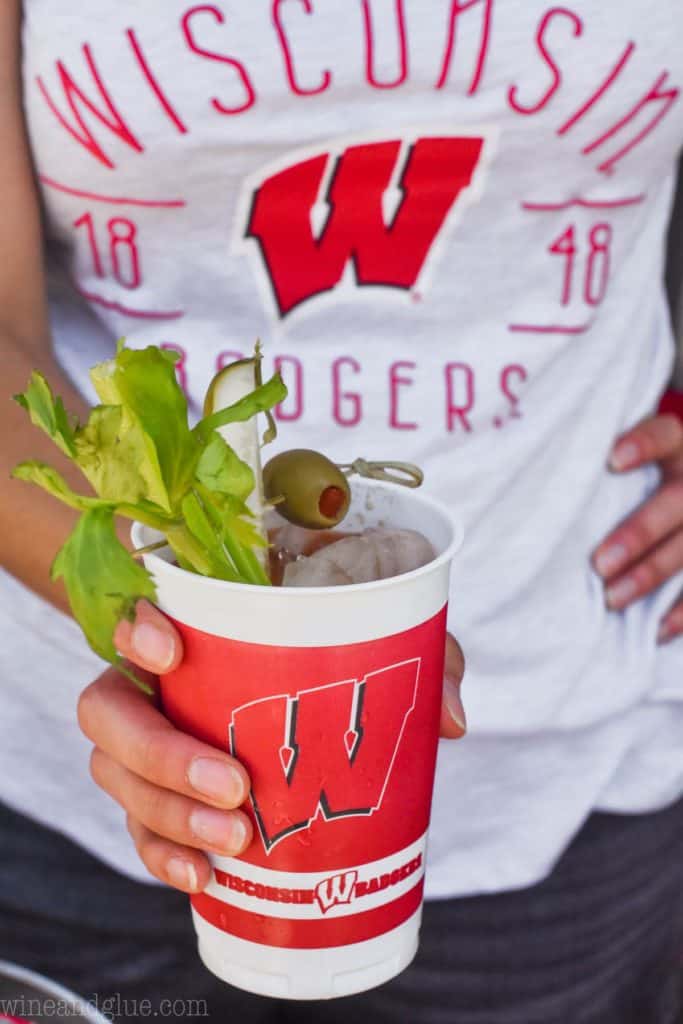 woman holding a uw cup filled with the perfect bloody mary mix