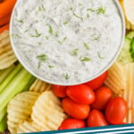 pinterest graphic of over head of dill vegetable dip recipe with chips and vegetables, says: the best dill dip simplejoy.com