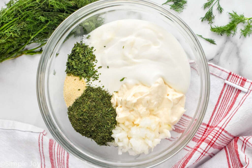 overhead of a bowl of ingredients for dill dip separated out