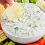 up close of chip being dipped into dill dip recipe