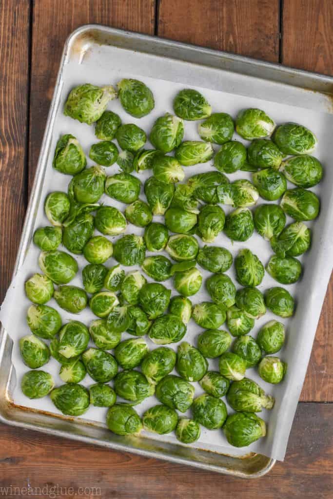 raw brussels sprouts on a baking sheet ready to be roasted