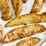 easy potato wedges on a parchment lined baking sheet