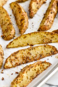 easy potato wedges on a parchment lined baking sheet