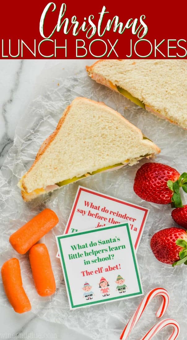 two christmas lunch box jokes with a sandwich, carrots, and strawberries