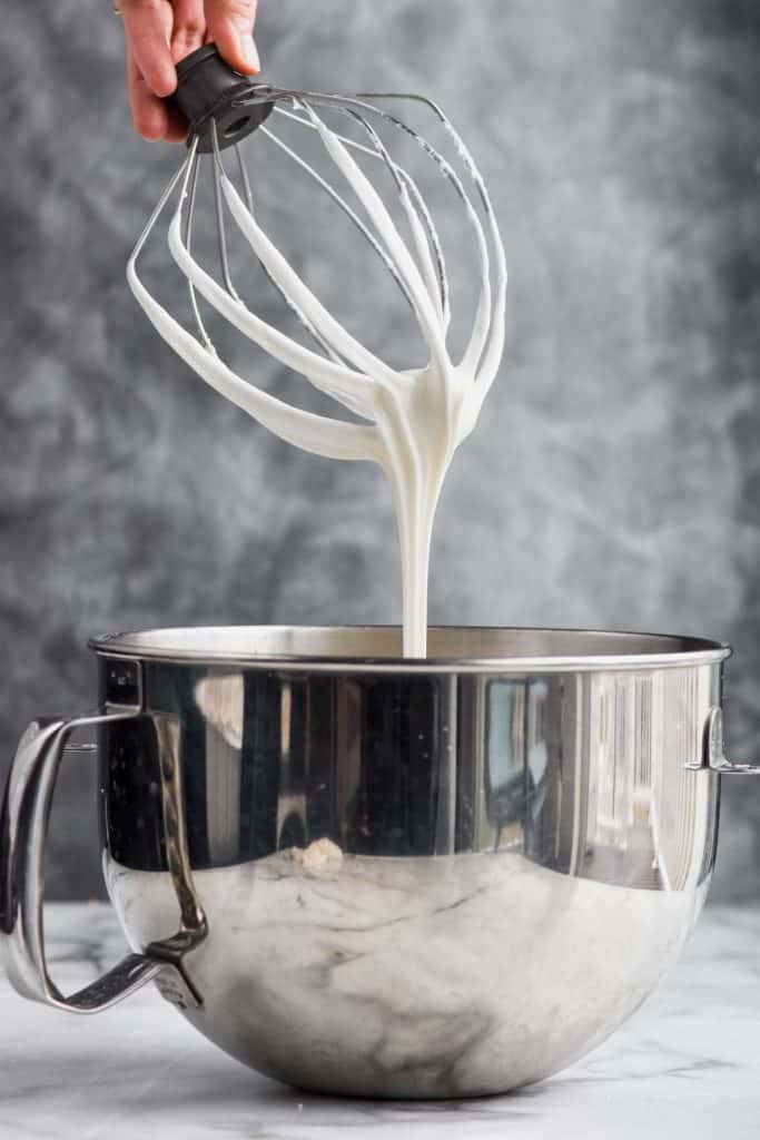 gingerbread icing being pulled from a mixing bowl