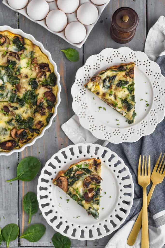 overhead view of two pieces of easy spinach quiche on white plates