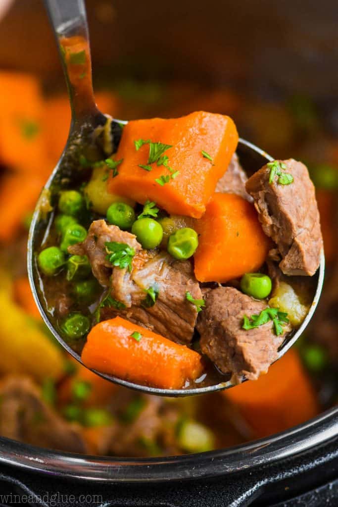 close of up of a ladle holding instant pot beef stew