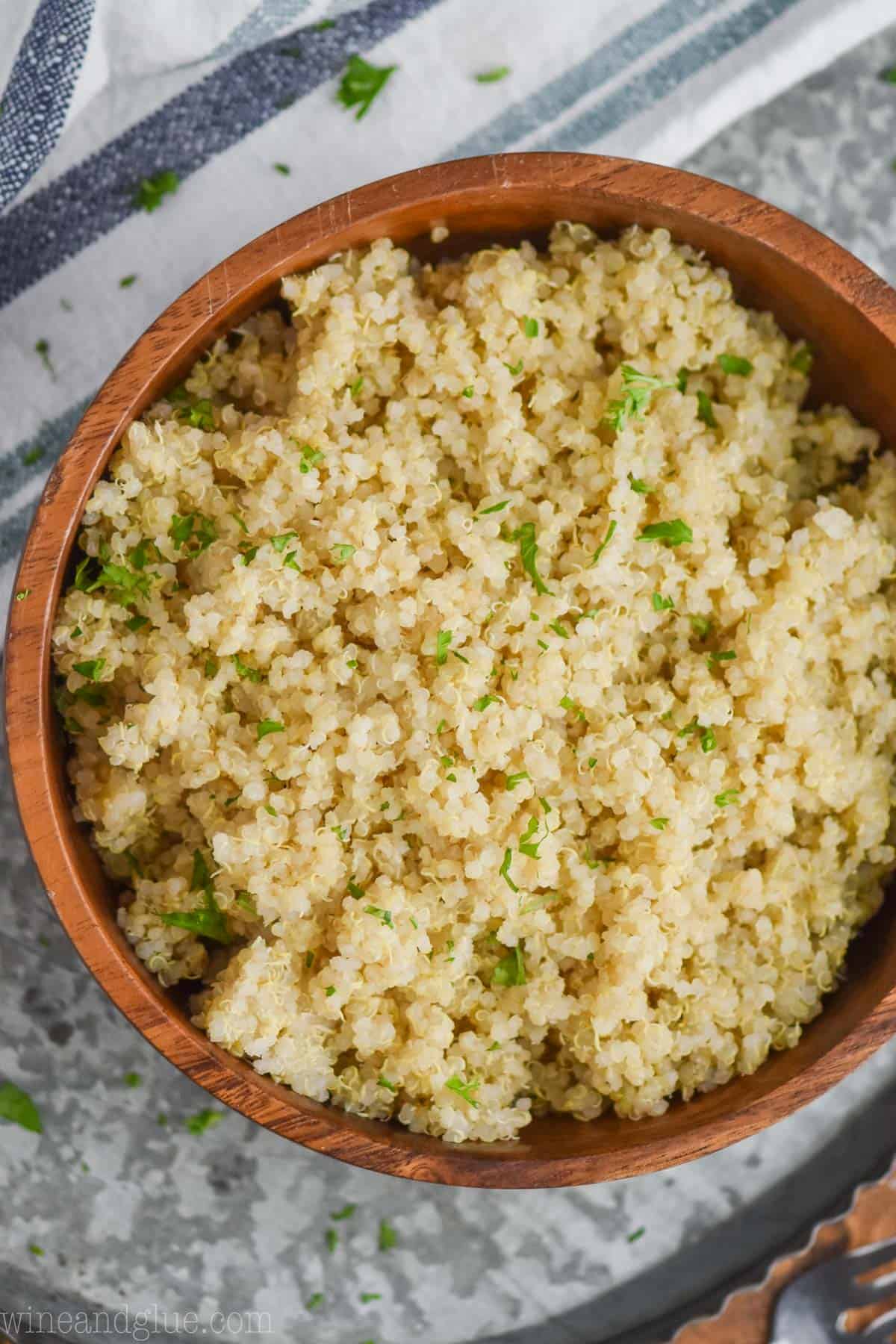 overhead view of quinoa that has been cooked in an instant pot in a small wooden bowl