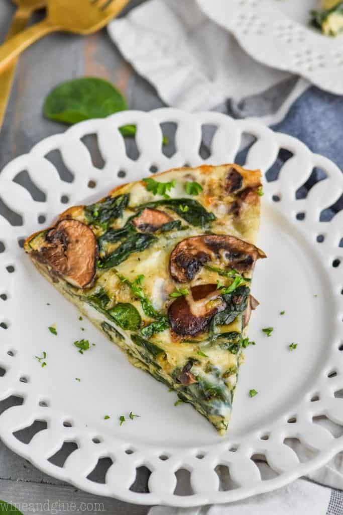 a piece of crustless spinach quiche on a white plate