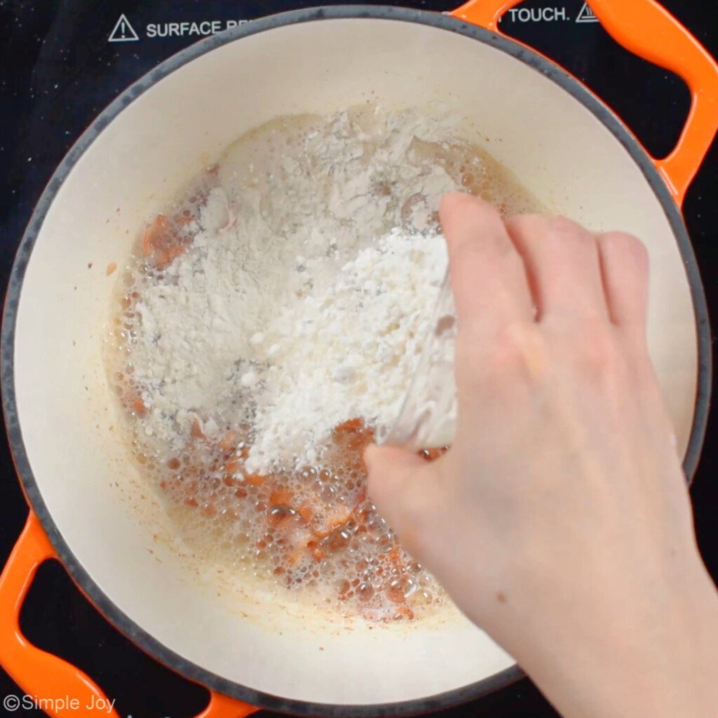 adding flour to a smalls sauce pan with cooking bacon