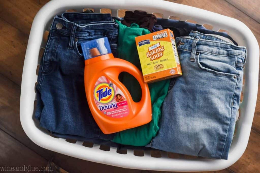 laundry basket with detergent and baking soda in it