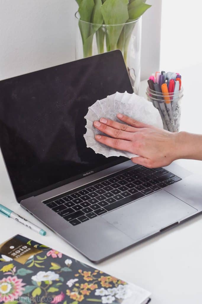 Using a coffee filter to clean dust off a computer screen.