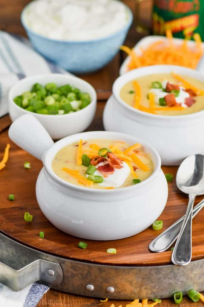 two bowls of loaded baked potato soup made in the slow cooker