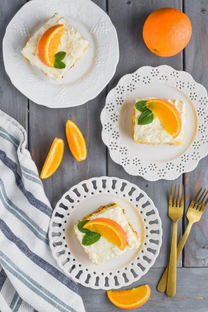 overhead view of three pieces of orange cake recipe on plates