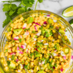 Pinterest graphic of overhead of a mixing bowl full of corn salsa, says "the best corn salsa recipe simplejoy.com"